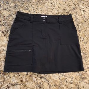 Black skort with zippered pockets.